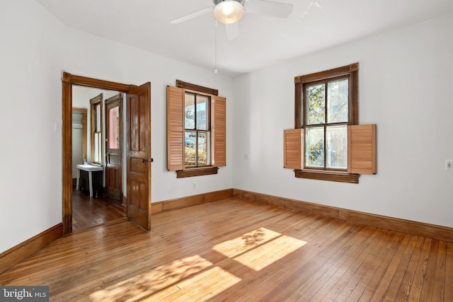 empty room featuring hardwood / wood-style floors and ceiling fan