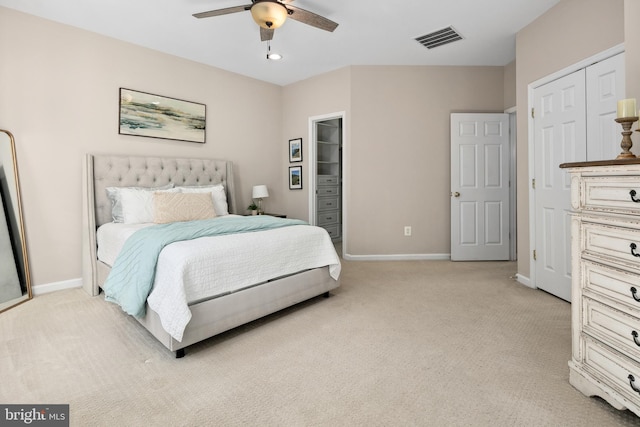 carpeted bedroom with a closet and ceiling fan