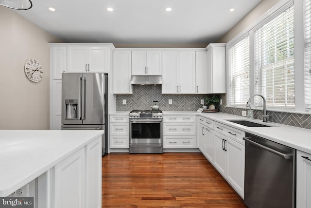 kitchen featuring sink, white cabinetry, tasteful backsplash, appliances with stainless steel finishes, and dark hardwood / wood-style flooring