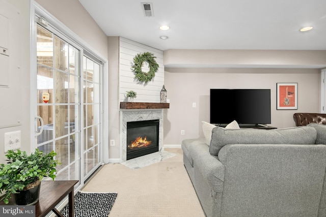 living room featuring a premium fireplace