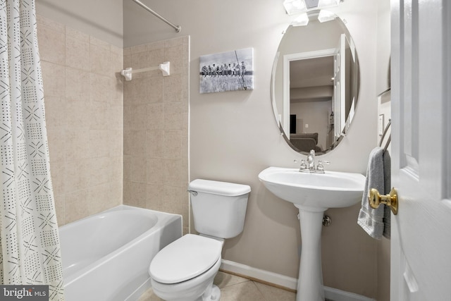 bathroom with shower / bath combo, tile patterned floors, and toilet