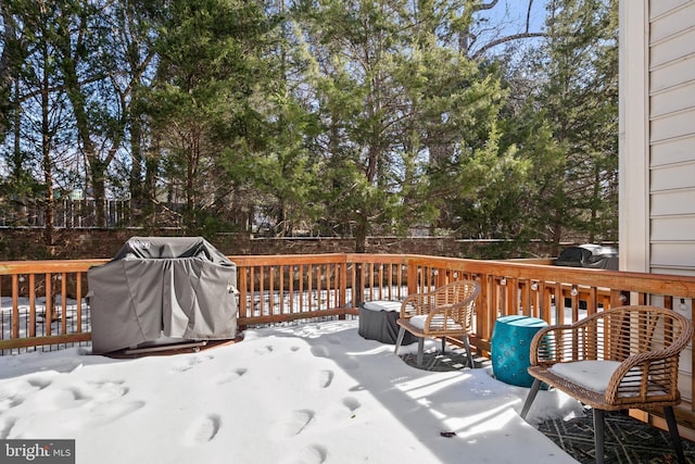 snow covered deck featuring a grill