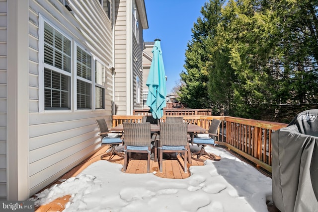 snow covered deck featuring area for grilling