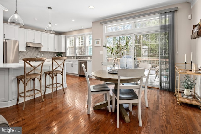 dining room with dark hardwood / wood-style flooring and sink