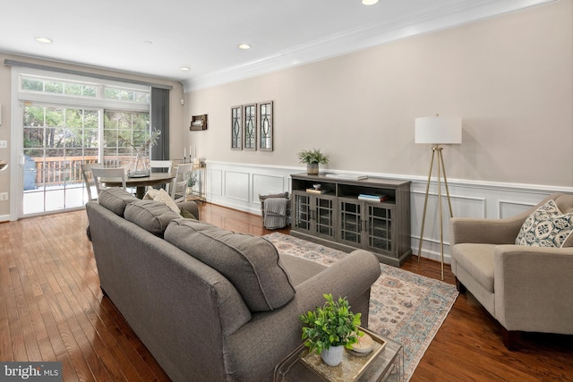 living room with ornamental molding and dark hardwood / wood-style floors