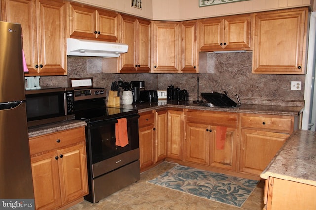 kitchen featuring stainless steel appliances and tasteful backsplash