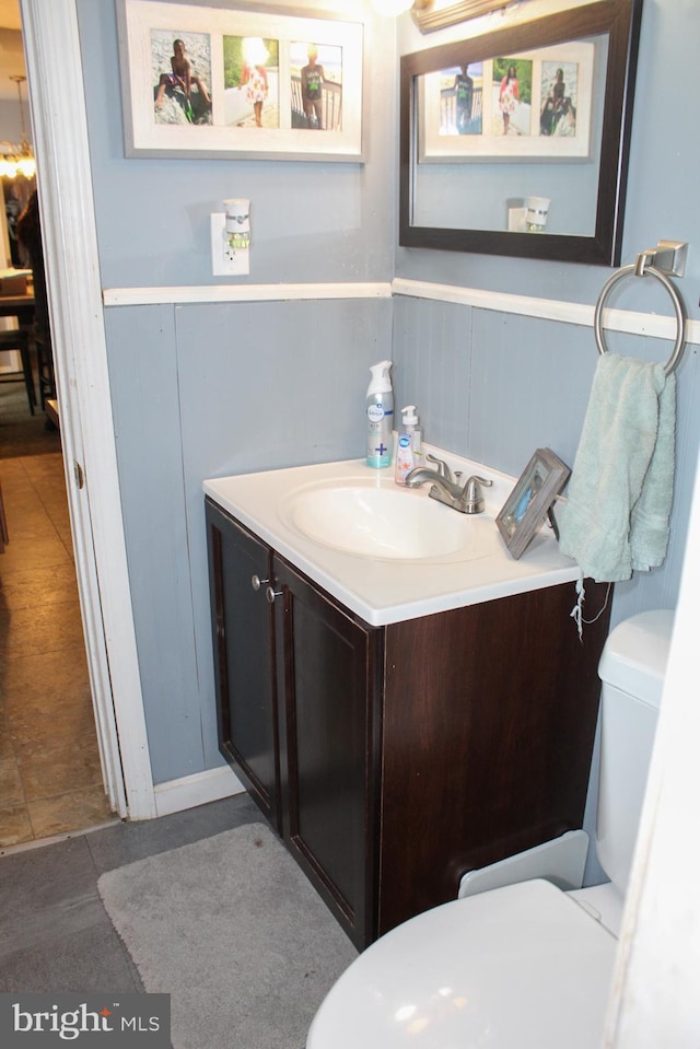 bathroom featuring toilet and vanity