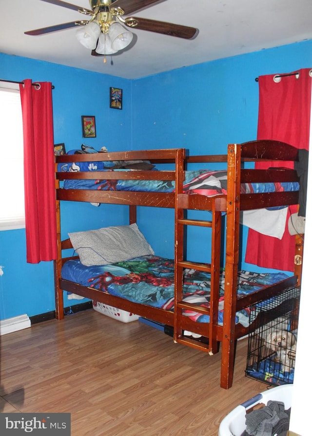 bedroom with ceiling fan and hardwood / wood-style floors