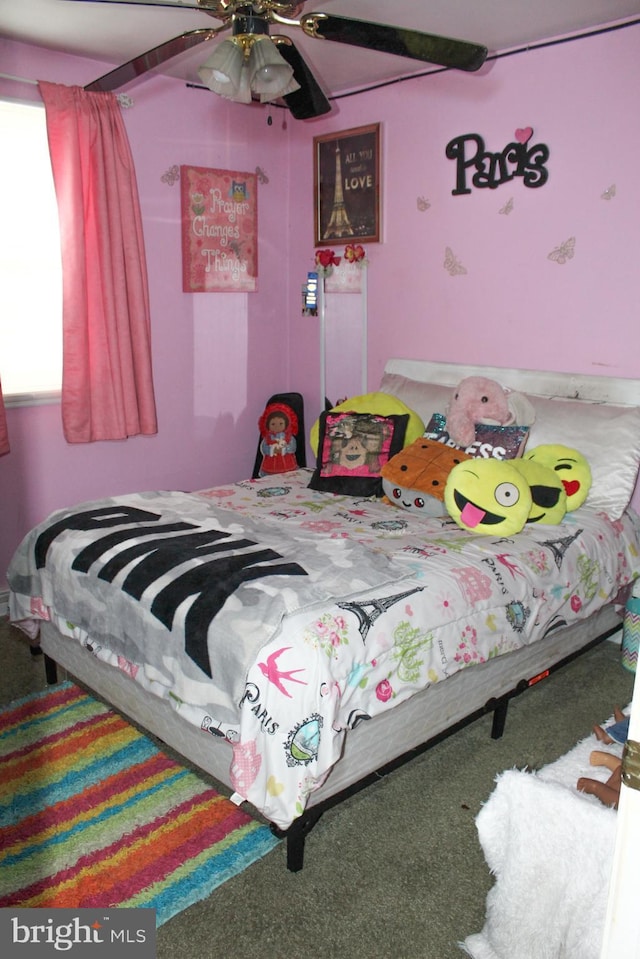 bedroom with ceiling fan, multiple windows, and carpet flooring