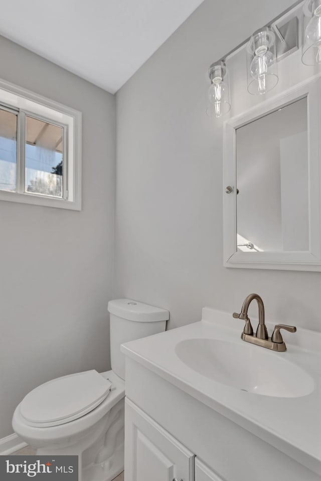 bathroom featuring toilet and vanity