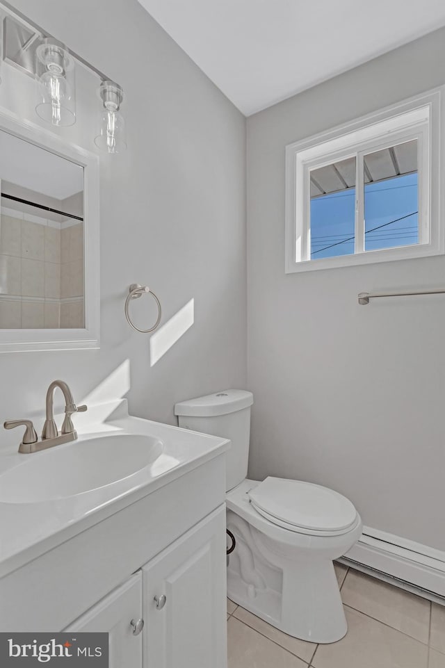 bathroom featuring baseboard heating, tile patterned floors, vanity, and toilet