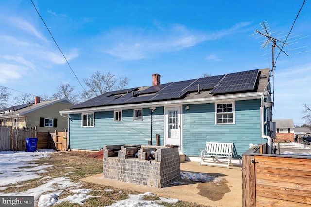 rear view of house with solar panels