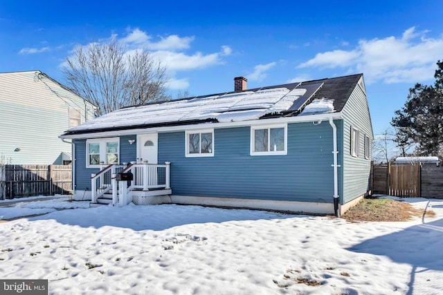 view of front of property featuring solar panels