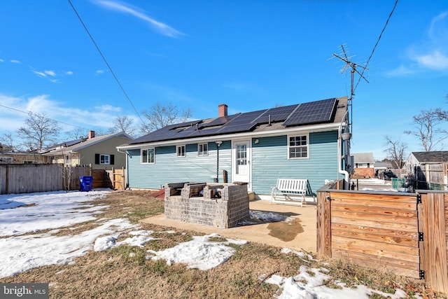 snow covered property with solar panels