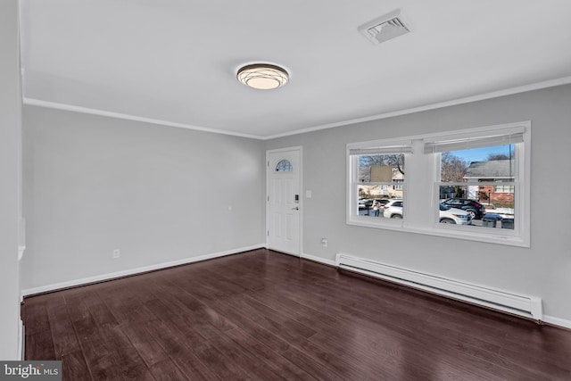 empty room with dark wood-type flooring, baseboard heating, and ornamental molding