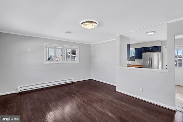 empty room with dark wood-type flooring, baseboard heating, plenty of natural light, and crown molding