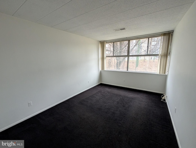 carpeted spare room with a textured ceiling