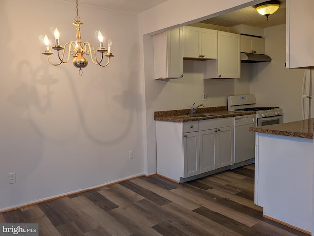 kitchen with white cabinetry, sink, hanging light fixtures, and white appliances