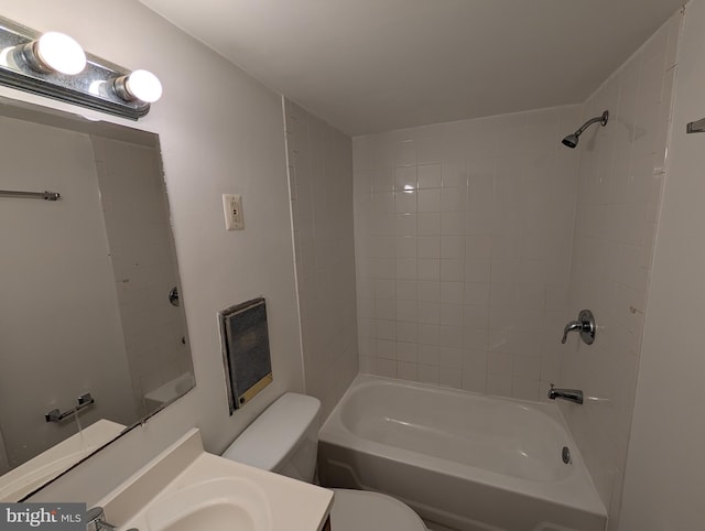 full bathroom with toilet, vanity, and tiled shower / bath combo