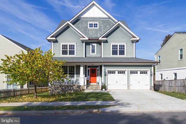 view of front of house featuring driveway, board and batten siding, an attached garage, and fence