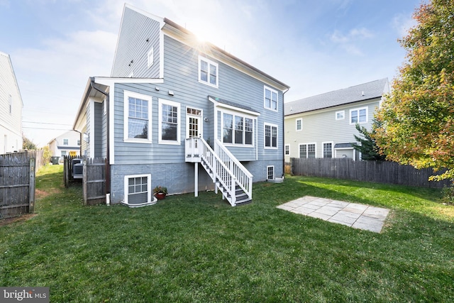 rear view of property featuring a yard and fence