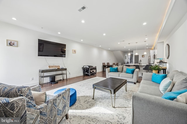 living room with sink and hardwood / wood-style floors