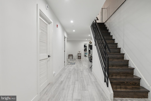 stairway with hardwood / wood-style flooring