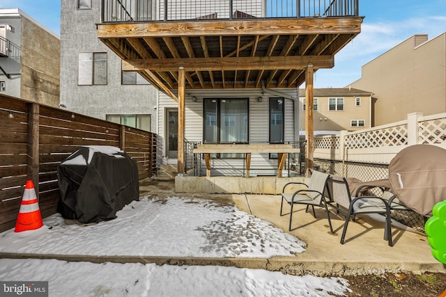 snow covered patio featuring area for grilling