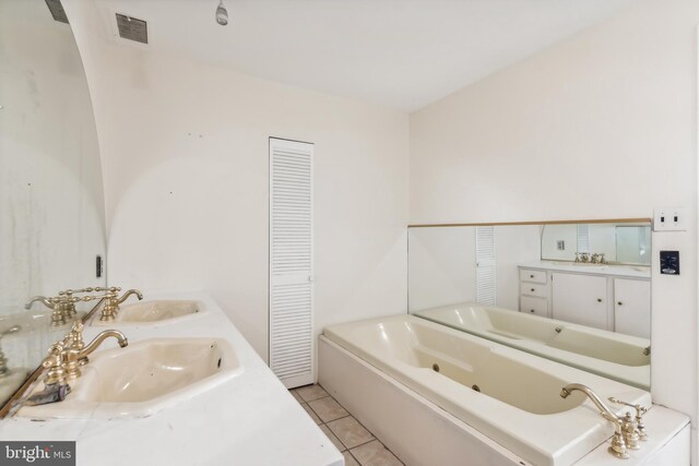 bathroom with vanity, a bathtub, and tile patterned floors