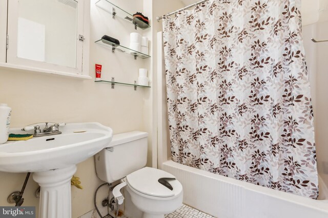 bathroom featuring tile patterned flooring, sink, and toilet