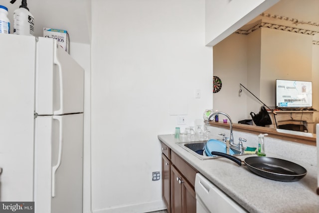 kitchen featuring sink and white appliances