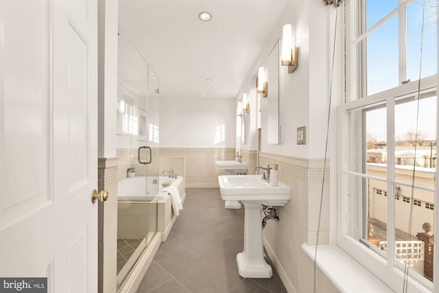 bathroom featuring tile patterned flooring and tiled tub