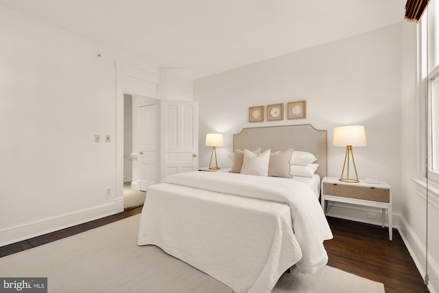 bedroom with dark hardwood / wood-style flooring