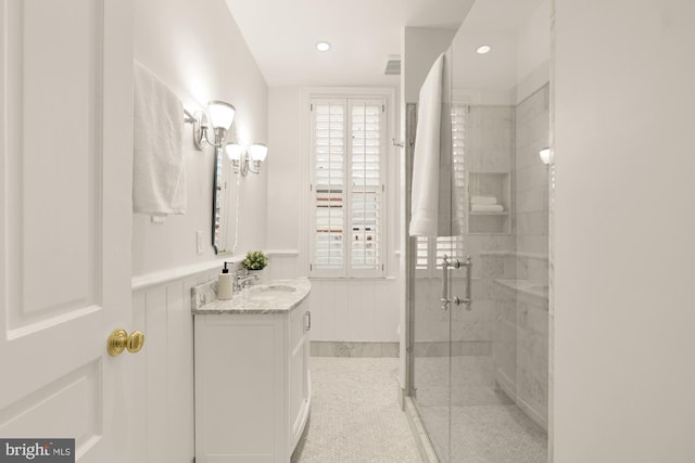 bathroom with vanity, a shower with shower door, and tile patterned floors