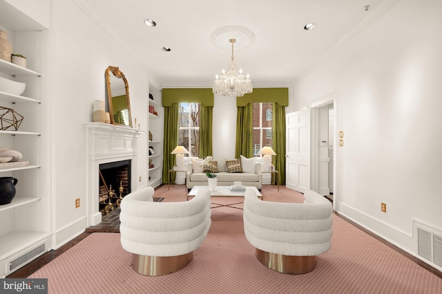 living room with ornamental molding, carpet, built in features, and a chandelier