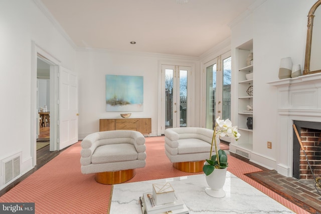 living area with ornamental molding and built in features