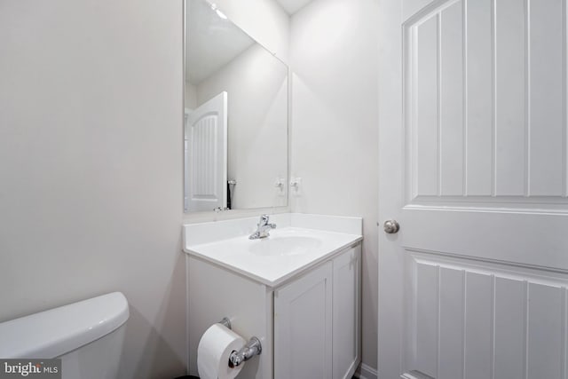 bathroom featuring toilet and vanity