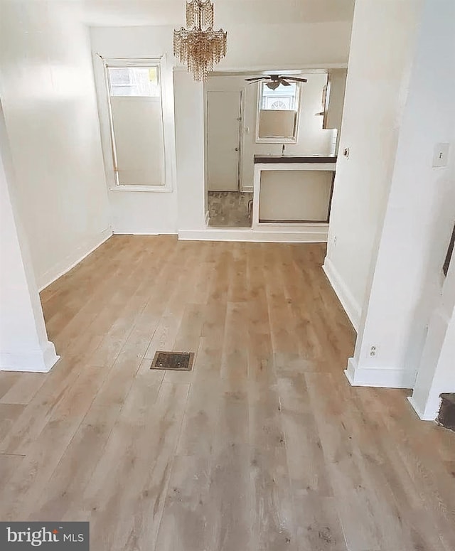 corridor with light hardwood / wood-style flooring