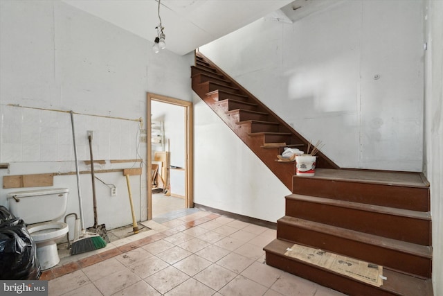 stairway featuring tile patterned floors