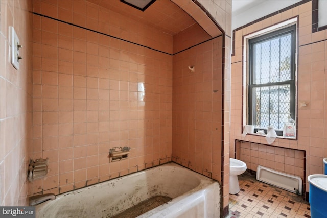 bathroom with toilet, a bathtub, baseboard heating, tile patterned flooring, and tile walls