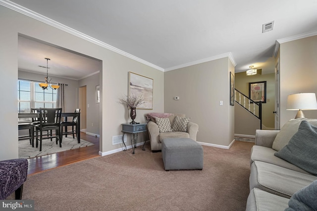 carpeted living room featuring ornamental molding and an inviting chandelier