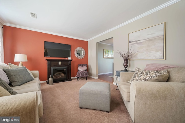 carpeted living room featuring ornamental molding