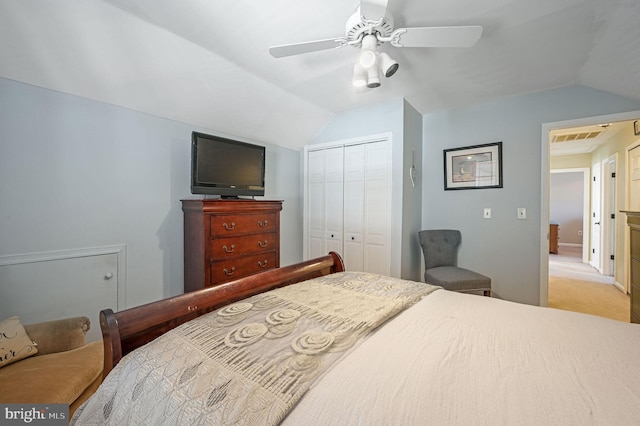 carpeted bedroom featuring ceiling fan, lofted ceiling, and a closet