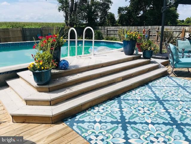 view of swimming pool featuring a wooden deck