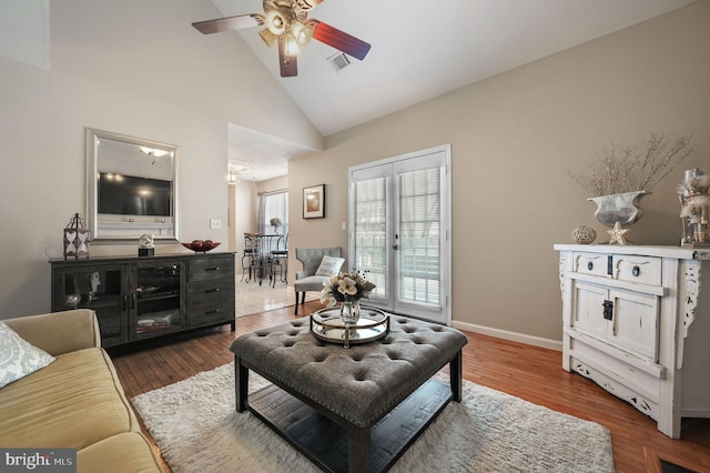 living room featuring hardwood / wood-style flooring, high vaulted ceiling, and ceiling fan