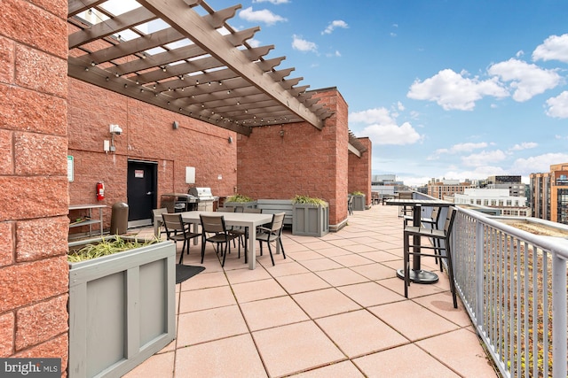 view of patio / terrace with grilling area and a pergola