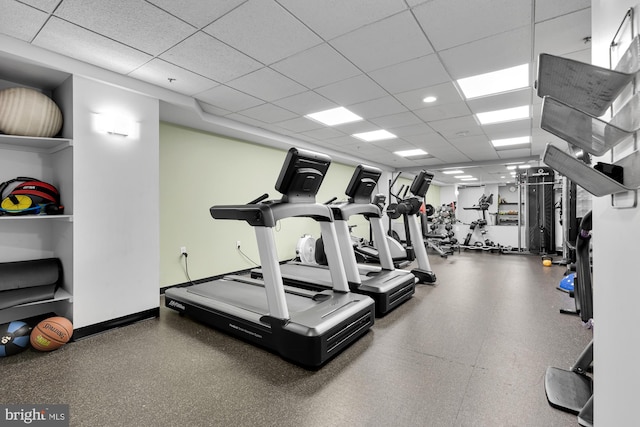 gym with a paneled ceiling