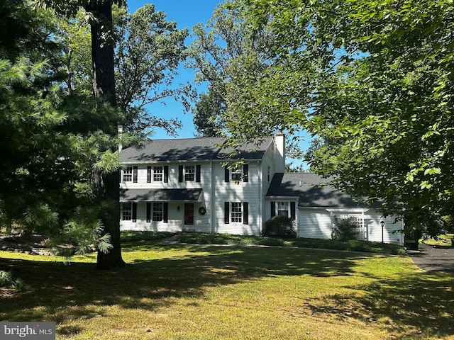 colonial home with a front yard