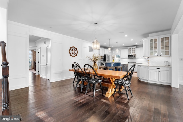 dining area featuring crown molding and dark hardwood / wood-style flooring