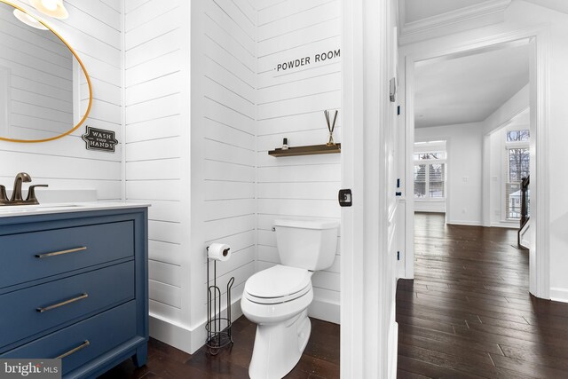 bathroom with vanity, toilet, and wood-type flooring